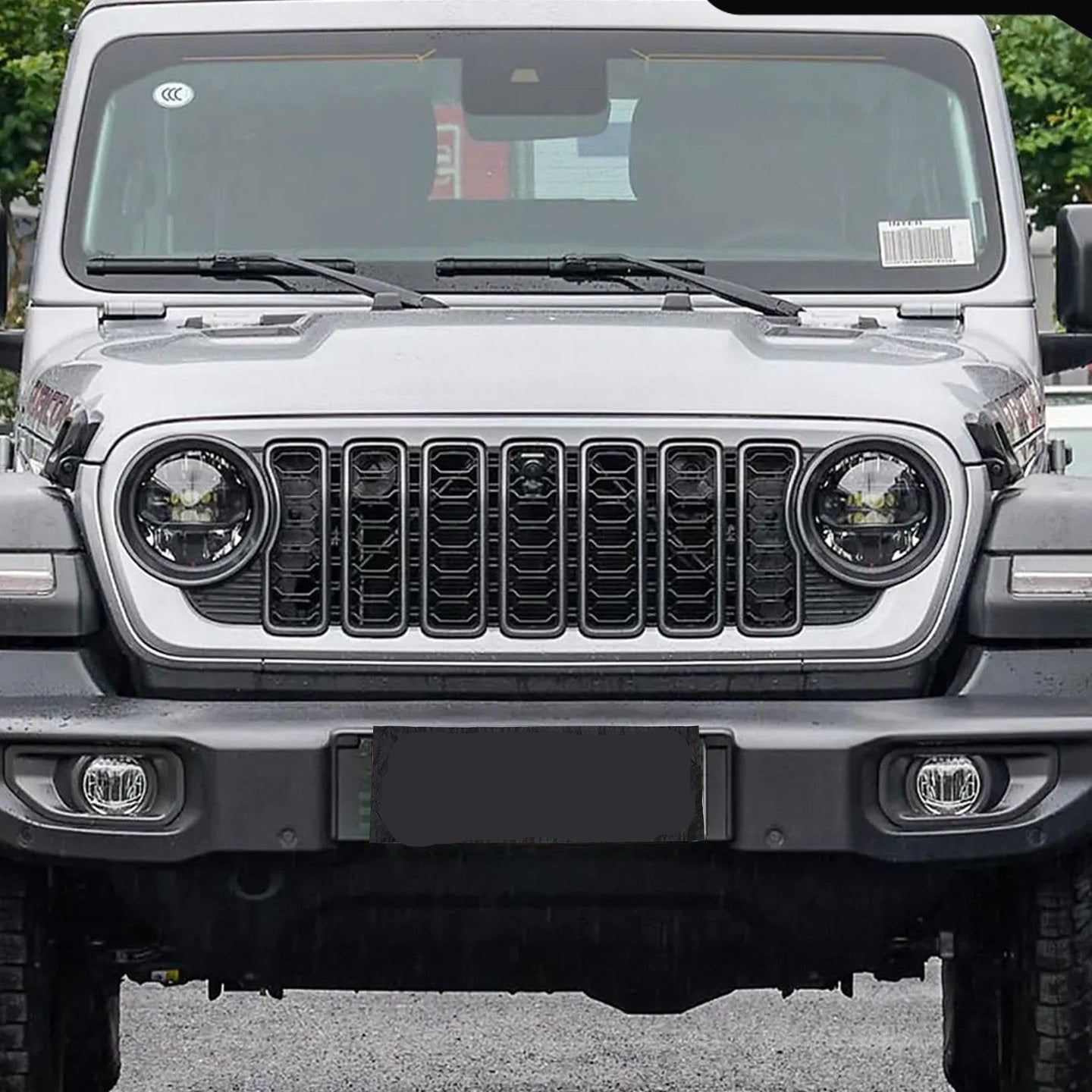 Front view of a white Jeep vehicle with a clear background