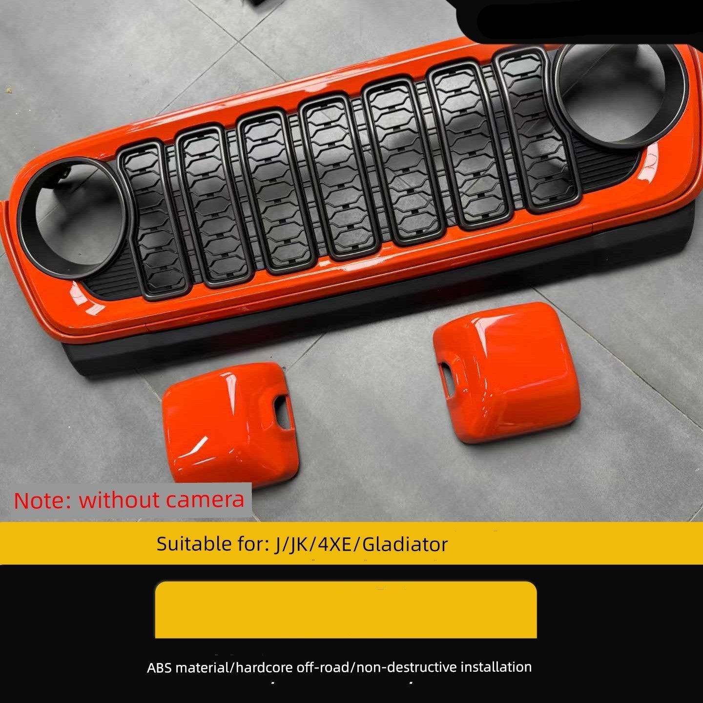Orange and black car grille with two covers on a gray floor, suitable for Jeep models.